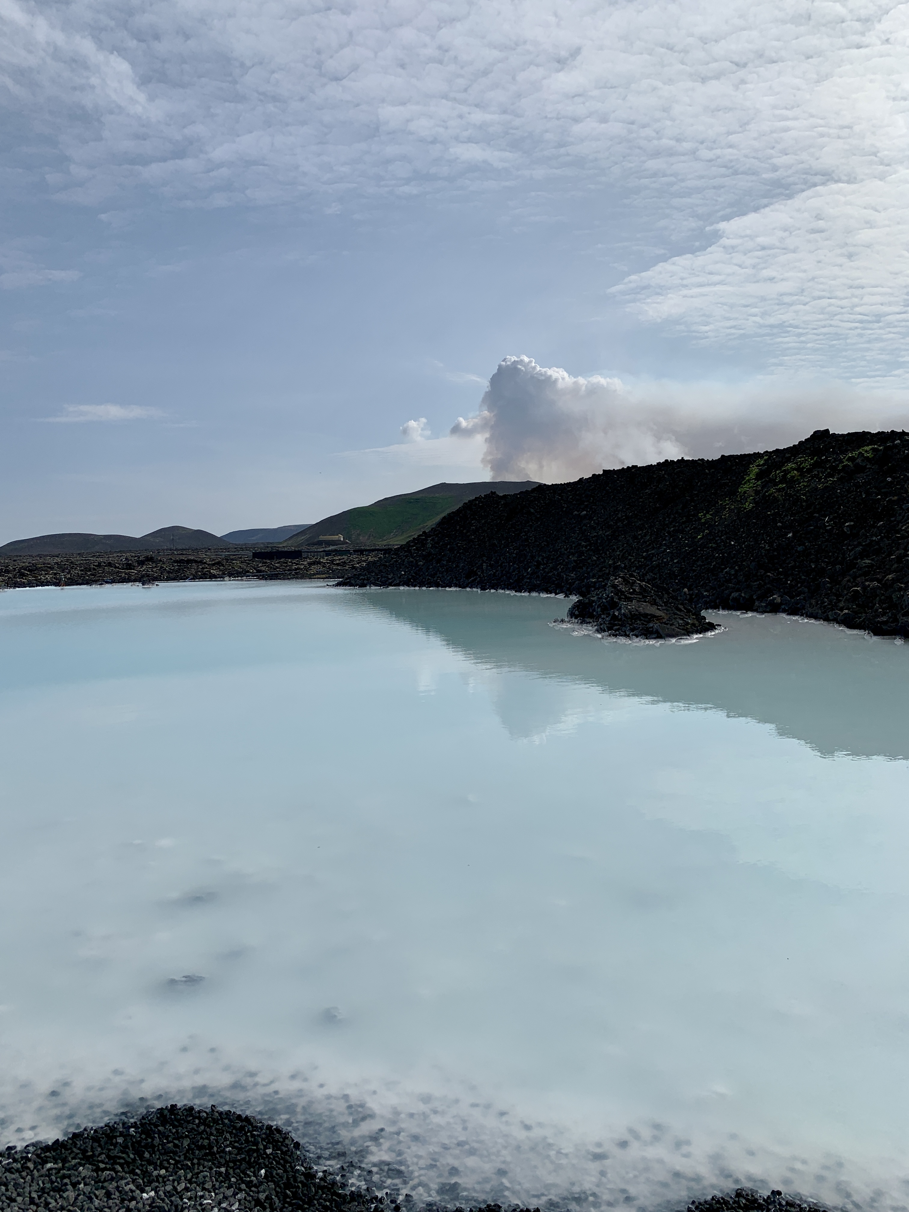 View of the smoking volcano in Iceland from the Blue Lagoon