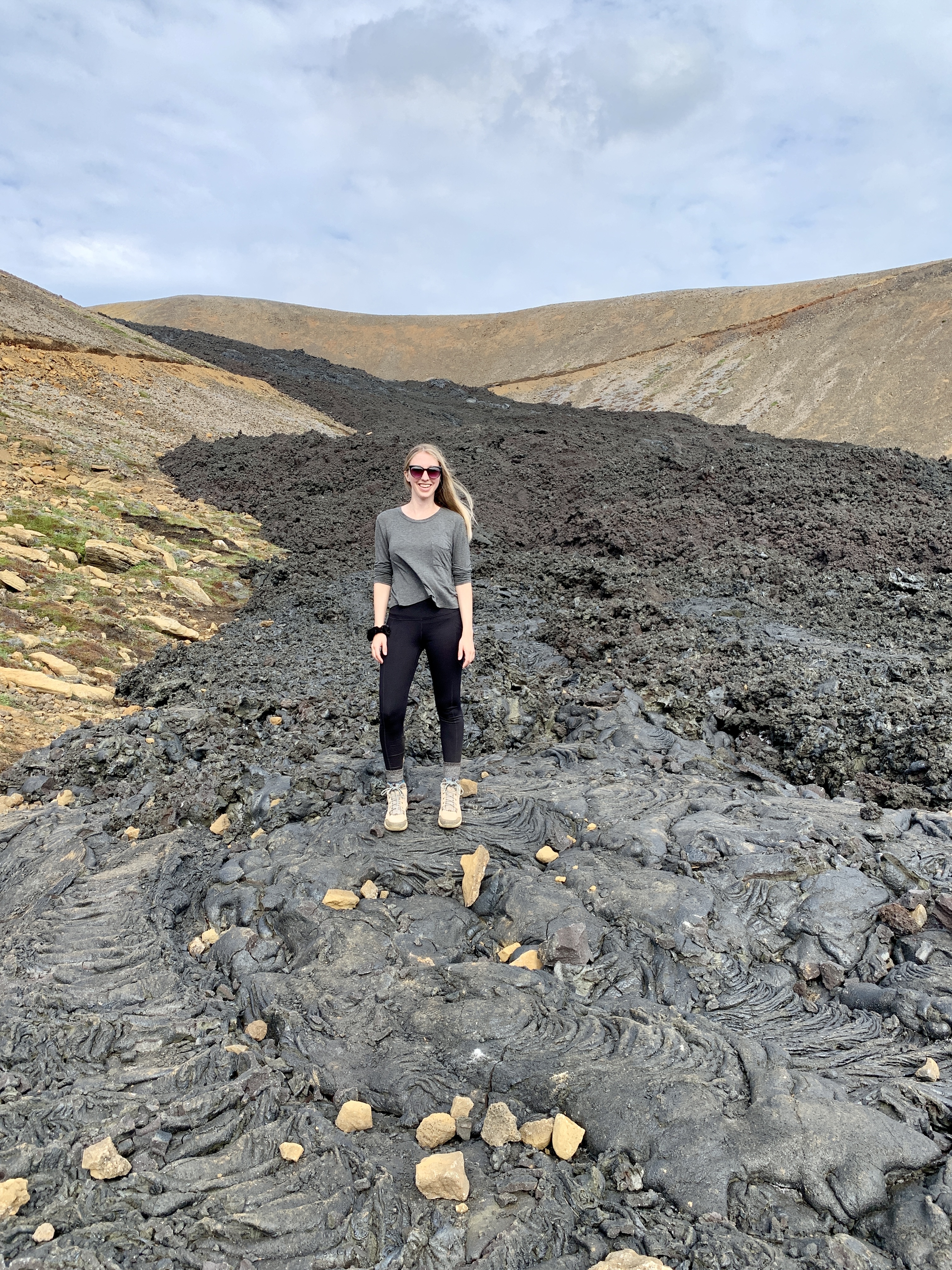 Amanda standing on black lava
