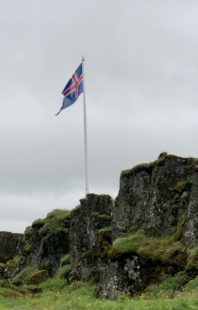 Icelandic flag flying in the wind at Thingvellir National Park