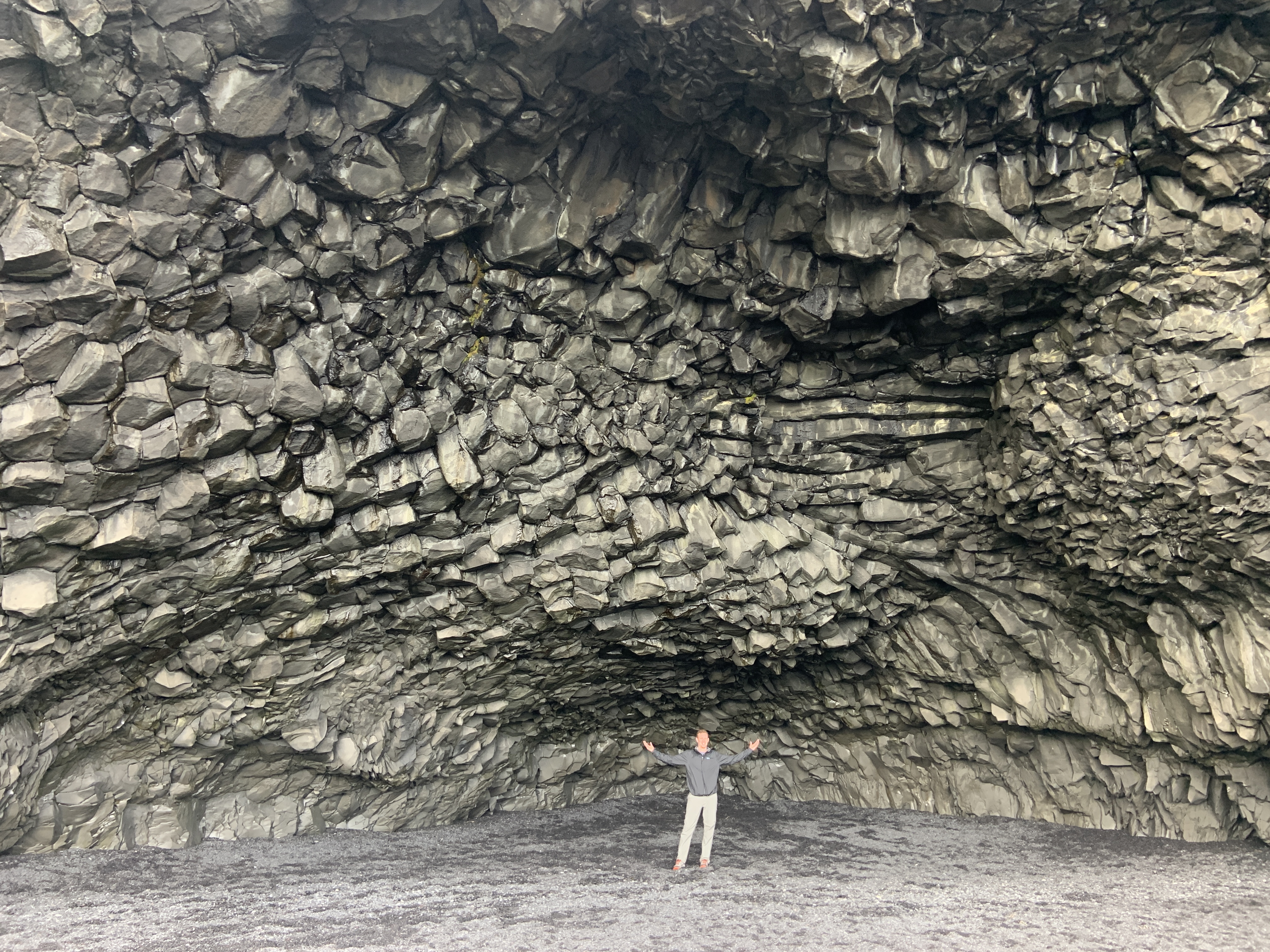 Mark in a large basalt cave on the Black Sand Beach in Iceland